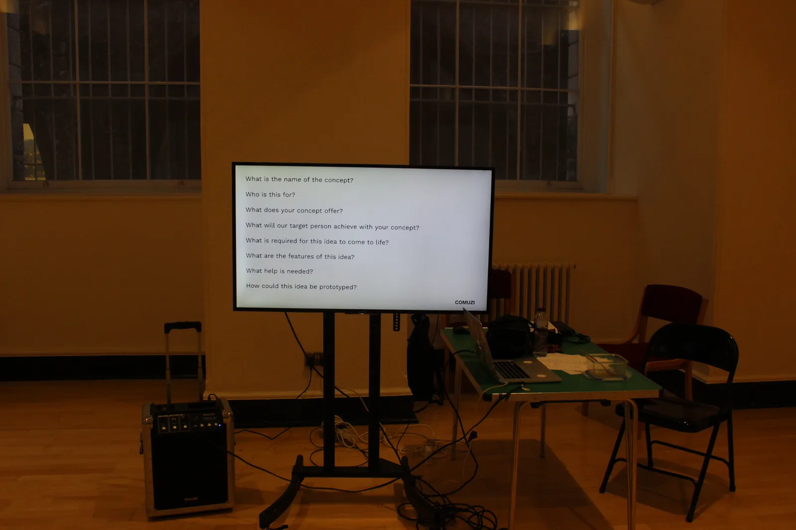 Concept development questions on screen at a co-design workshop