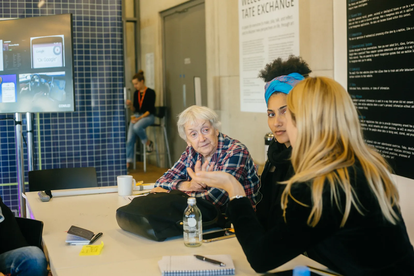 A table conversation at Tate Exchange, with the programme running on screen behind