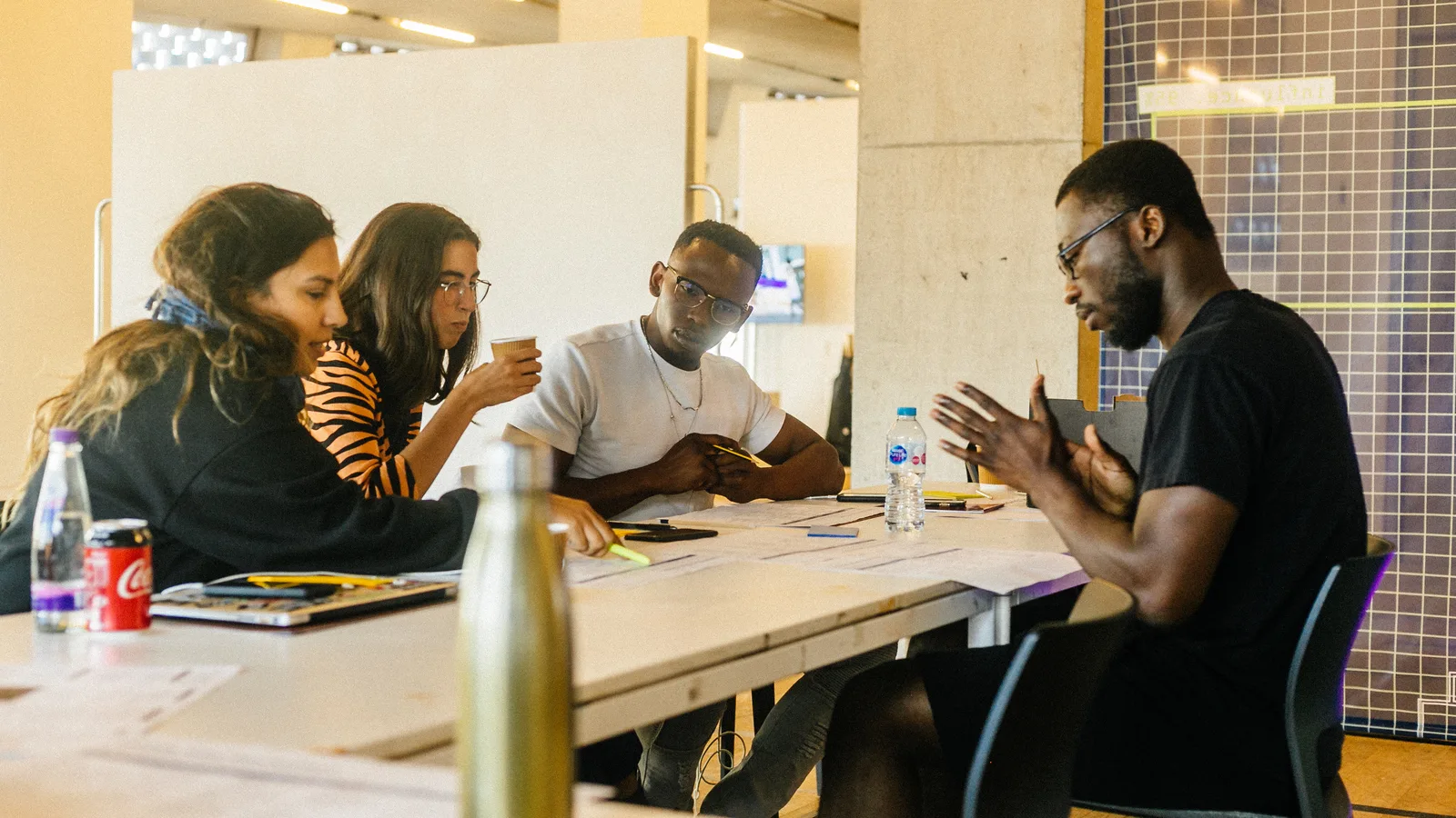 Participants in discussion around a worktable