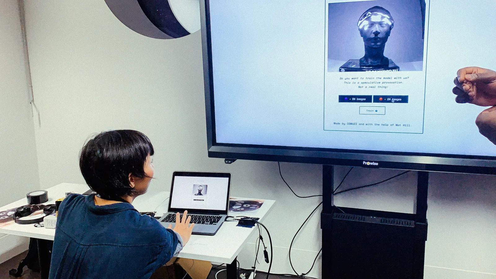 The exhibit interface inviting visitors to train a facial recognition model on the mask